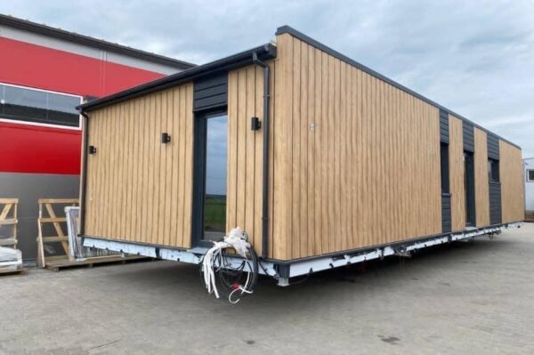 The Full Basics 8 Ft W X 30 Ft L X 9.5 Ft T 240 Sq.Ft. Weight Approx. 10,000 Lb 50 Amp Panel / 220W Plug In Included Modern Fiberglass Front Door Luxury Vinyl Plank Floors Dual Pane Tempered Glass Vinyl Frame Windows And Sliding Door Shiplap Paneling On Ceiling Aluminum Frame Glass Roll Up Garage Door 2”X3” Lumber Framing And Drywall Closed Cell Spray Foam Insulated (3” Walls And Ceiling) Shaker Style Wood Cabinets In Kitchen, Bath, And 2 Bedrooms Smoke Detector And Fire Extinguisher Tankless Propane Water Heater Pioneer Mini Split 9,000 BTU Solar Power / Tech (3) 320W Mono Solar Panels, 3000W Go Power Inverter (4) 500W Full River Solar Batteries, Mounting Rails, Propane 4 Burner Stove Electric Range Exhaust System Summit 7 Cu.Ft. Refrigerator Bathroom Ceramic Subway Tile Shower Moen Faucet And Shower Head Shaker Wood Vanity With Acacia Wood Counter Top, Farmhouse Sit On Top Sink Swiss Madison Dual Flush Toilet (Nature’s Head Composting Toilet - Image 3
