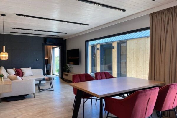 The Full Basics 8 Ft W X 30 Ft L X 9.5 Ft T 240 Sq.Ft. Weight Approx. 10,000 Lb 50 Amp Panel / 220W Plug In Included Modern Fiberglass Front Door Luxury Vinyl Plank Floors Dual Pane Tempered Glass Vinyl Frame Windows And Sliding Door Shiplap Paneling On Ceiling Aluminum Frame Glass Roll Up Garage Door 2”X3” Lumber Framing And Drywall Closed Cell Spray Foam Insulated (3” Walls And Ceiling) Shaker Style Wood Cabinets In Kitchen, Bath, And 2 Bedrooms Smoke Detector And Fire Extinguisher Tankless Propane Water Heater Pioneer Mini Split 9,000 BTU Solar Power / Tech (3) 320W Mono Solar Panels, 3000W Go Power Inverter (4) 500W Full River Solar Batteries, Mounting Rails, Propane 4 Burner Stove Electric Range Exhaust System Summit 7 Cu.Ft. Refrigerator Bathroom Ceramic Subway Tile Shower Moen Faucet And Shower Head Shaker Wood Vanity With Acacia Wood Counter Top, Farmhouse Sit On Top Sink Swiss Madison Dual Flush Toilet (Nature’s Head Composting Toilet - Image 7