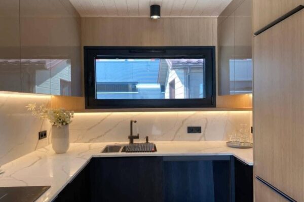 The Full Basics 8 Ft W X 30 Ft L X 9.5 Ft T 240 Sq.Ft. Weight Approx. 10,000 Lb 50 Amp Panel / 220W Plug In Included Modern Fiberglass Front Door Luxury Vinyl Plank Floors Dual Pane Tempered Glass Vinyl Frame Windows And Sliding Door Shiplap Paneling On Ceiling Aluminum Frame Glass Roll Up Garage Door 2”X3” Lumber Framing And Drywall Closed Cell Spray Foam Insulated (3” Walls And Ceiling) Shaker Style Wood Cabinets In Kitchen, Bath, And 2 Bedrooms Smoke Detector And Fire Extinguisher Tankless Propane Water Heater Pioneer Mini Split 9,000 BTU Solar Power / Tech (3) 320W Mono Solar Panels, 3000W Go Power Inverter (4) 500W Full River Solar Batteries, Mounting Rails, Propane 4 Burner Stove Electric Range Exhaust System Summit 7 Cu.Ft. Refrigerator Bathroom Ceramic Subway Tile Shower Moen Faucet And Shower Head Shaker Wood Vanity With Acacia Wood Counter Top, Farmhouse Sit On Top Sink Swiss Madison Dual Flush Toilet (Nature’s Head Composting Toilet - Image 8