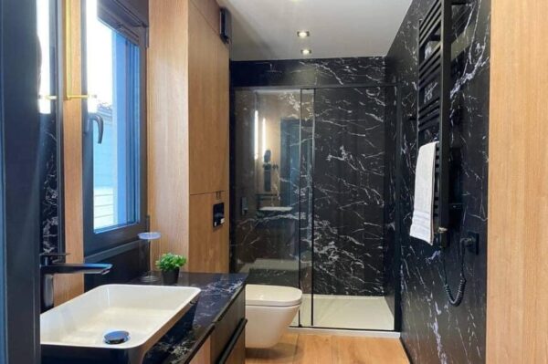 The Full Basics 8 Ft W X 30 Ft L X 9.5 Ft T 240 Sq.Ft. Weight Approx. 10,000 Lb 50 Amp Panel / 220W Plug In Included Modern Fiberglass Front Door Luxury Vinyl Plank Floors Dual Pane Tempered Glass Vinyl Frame Windows And Sliding Door Shiplap Paneling On Ceiling Aluminum Frame Glass Roll Up Garage Door 2”X3” Lumber Framing And Drywall Closed Cell Spray Foam Insulated (3” Walls And Ceiling) Shaker Style Wood Cabinets In Kitchen, Bath, And 2 Bedrooms Smoke Detector And Fire Extinguisher Tankless Propane Water Heater Pioneer Mini Split 9,000 BTU Solar Power / Tech (3) 320W Mono Solar Panels, 3000W Go Power Inverter (4) 500W Full River Solar Batteries, Mounting Rails, Propane 4 Burner Stove Electric Range Exhaust System Summit 7 Cu.Ft. Refrigerator Bathroom Ceramic Subway Tile Shower Moen Faucet And Shower Head Shaker Wood Vanity With Acacia Wood Counter Top, Farmhouse Sit On Top Sink Swiss Madison Dual Flush Toilet (Nature’s Head Composting Toilet - Image 9